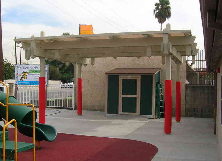 Safety Pole Pad - Square 6 Foot Tall red wrap-around pole pad on playground shade structure pole in outdoor play area