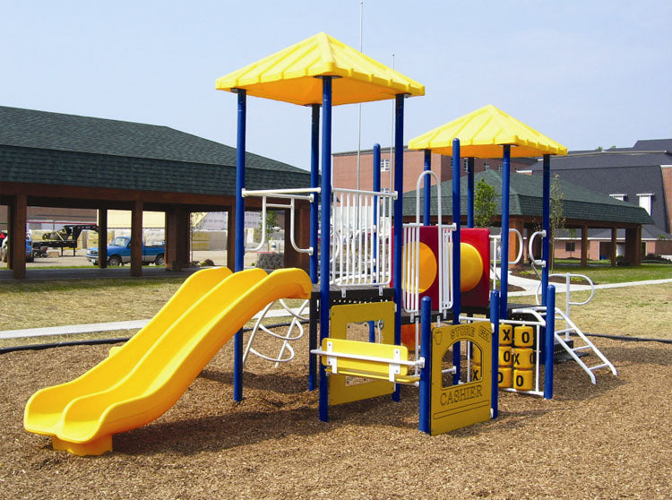 Colorful modular playground with double yellow slides, crawl tunnel, tic tac toe panel, and climbing features on wood chip ground