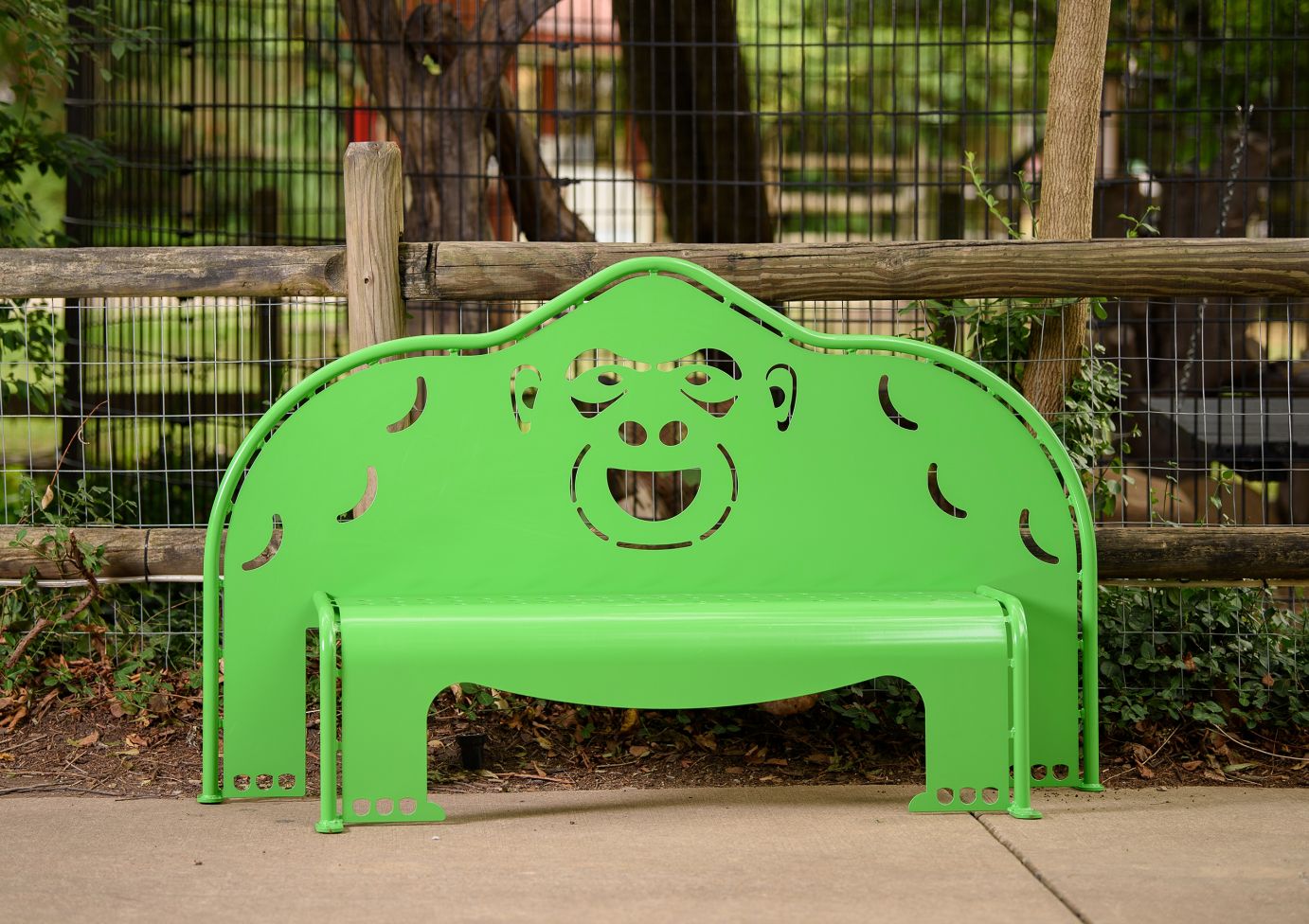 4' Gorilla Bench in bright green metal with gorilla face cutout, durable outdoor park bench for play areas
