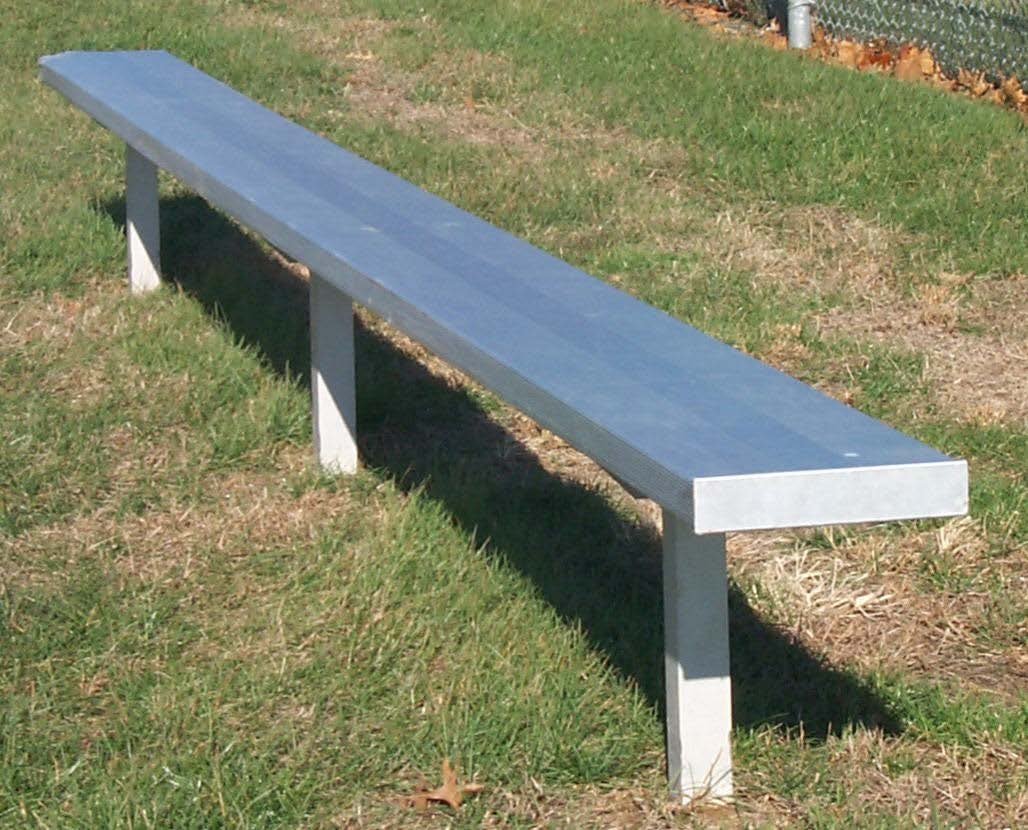 Long sleek outdoor bench with anodized aluminum seat plank and sturdy metal legs on grass