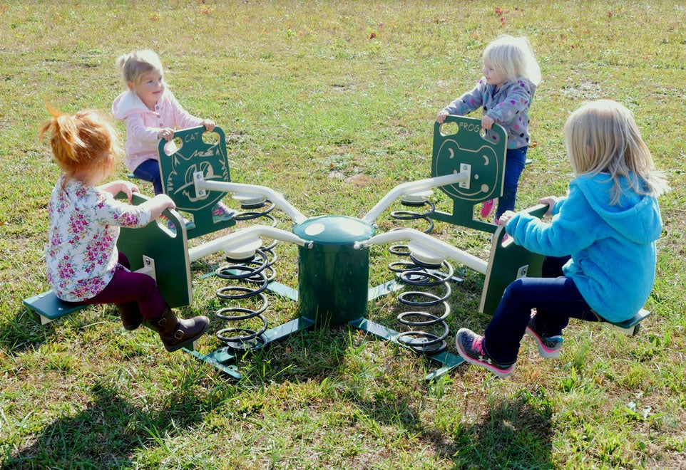 Animal Spring-About Multi-Person Spring Rider with four children seated on colorful animal-themed spring riders on grass in outdoor play area