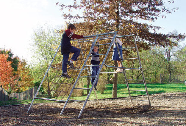 Galvanized steel pipe climbing frame with plastic-covered net and sloped sides on wood chip ground outdoors