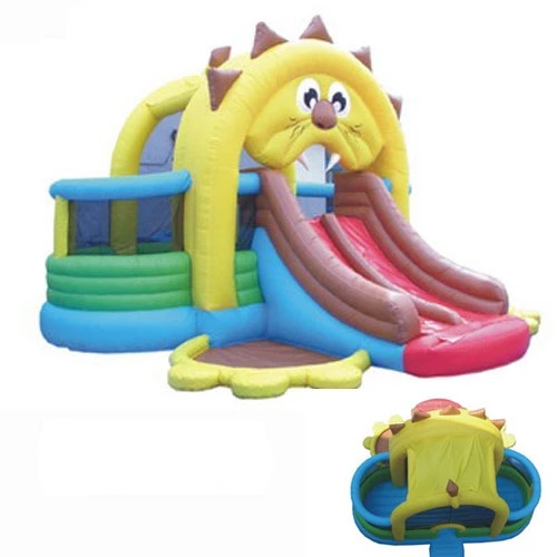 Inflatable lion-themed bounce house with dual red slides, climbing wall, shaded bounce area, and separate play zones.
