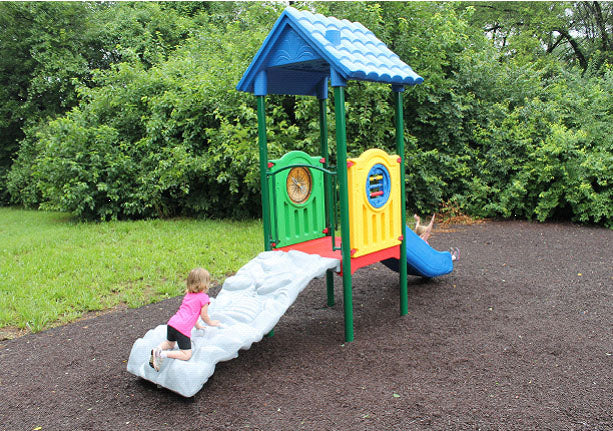 Marco Polo Explorer Center Early Childhood Playground with dinosaur fossil climber, roof, activity panels, and river rapids slide on mulch surface