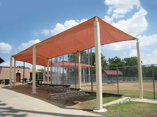 Wrap Around Shade Structure with orange fabric canopy over benches at baseball field, providing UV protection and shade