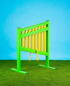 Bright green outdoor musical chimes with yellow bars on artificial grass for children's playground musical play and exploration
