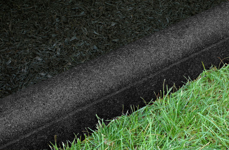 Rubberific Playground Border Timbers in classic black, curved flexible rubber border between grass and mulch