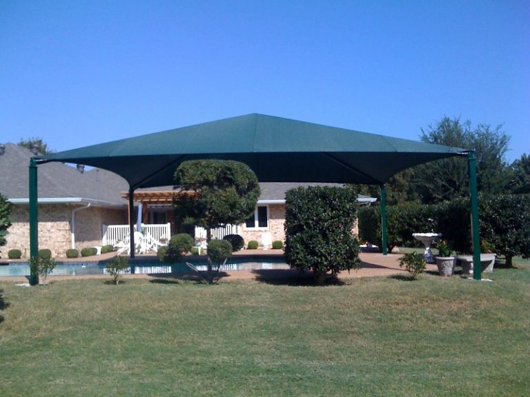 Rectangular hip roof shade structure with four posts and green fabric canopy over a backyard pool area