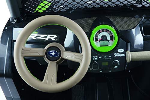 Overhead view of green-accented dashboard and beige steering wheel of children's electric ride-on vehicle with speedometer and FM radio controls