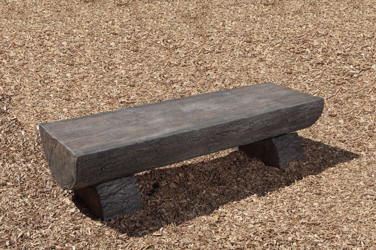 Nature Themed Log Bench with realistic wood grain and bark finish on wood chip ground surface