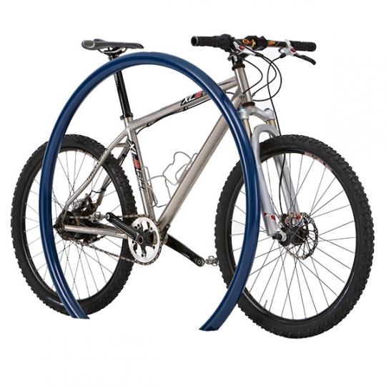 Blue powder-coated steel bike rack with large hoop design holding a silver mountain bike