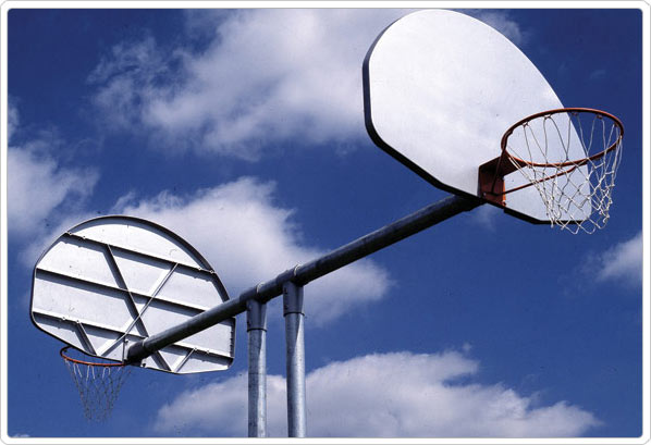 Double Basketball Goal with aluminum fan backboards and galvanized steel posts against blue sky with clouds