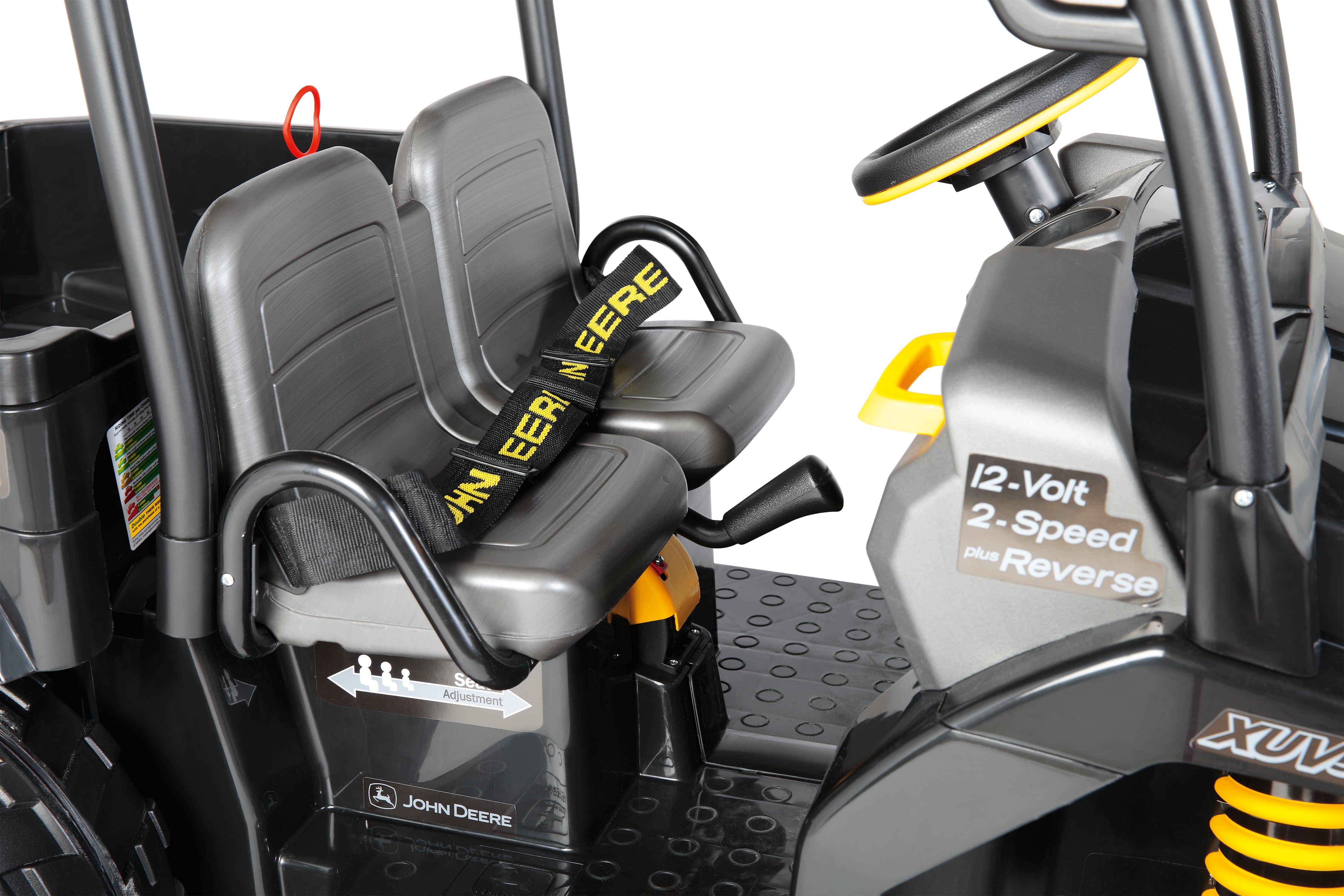 Black ride-on vehicle interior with two gray seats, yellow-accented steering wheel, seatbelt, and control lever