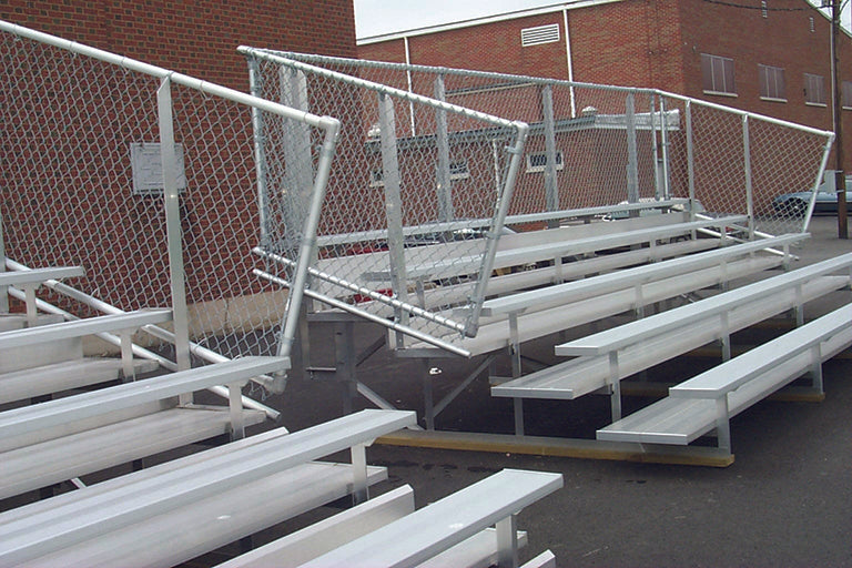 8 Row Preferred Bleachers with aluminum seating and chain-link guardrail, outdoor sports seating near brick building