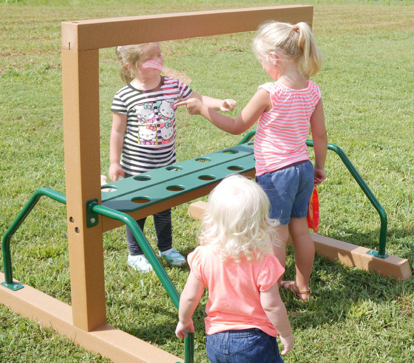 Three children collaboratively painting and drawing on a transparent outdoor group art easel panel