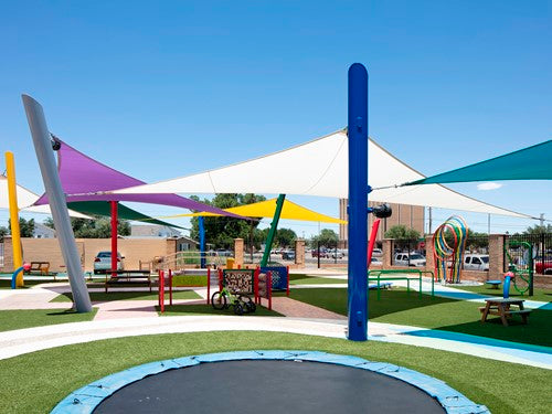 Colorful 4-point hypar sail shade with hyperbolic fabric shapes over playground equipment and trampoline