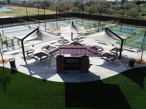Solana Cantilever Single Post Shade Structure with three large cantilevered fabric shades over picnic tables at outdoor pickleball courts in Anthem, AZ