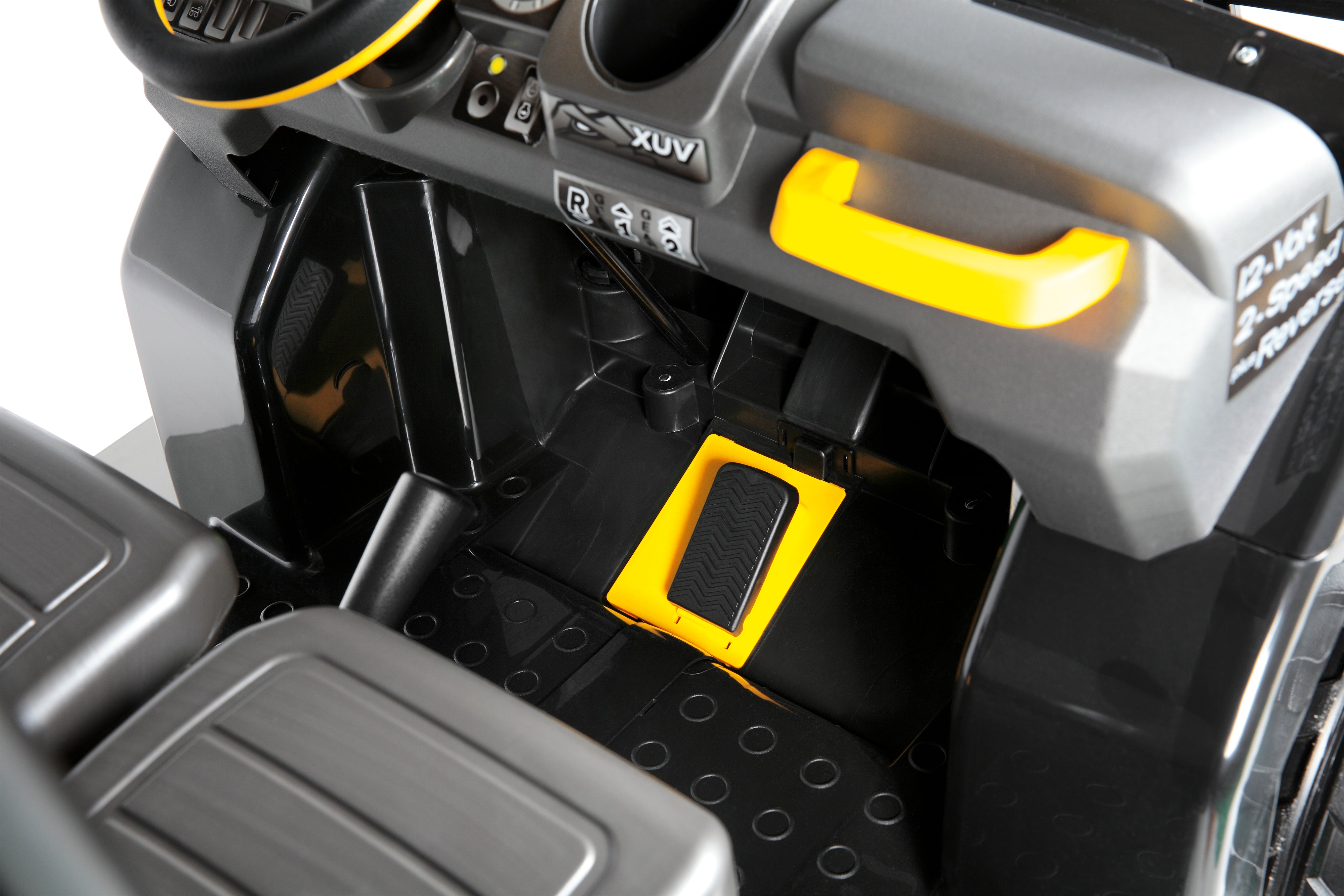 Close-up of black and yellow pedal and dashboard controls inside a children's ride-on vehicle with sporty design and safety features