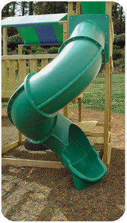 Green curved turbo tube slide attached to wooden playset deck over textured ground surface