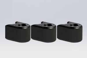 Three black plastic playground border filler ends aligned side by side on a neutral surface