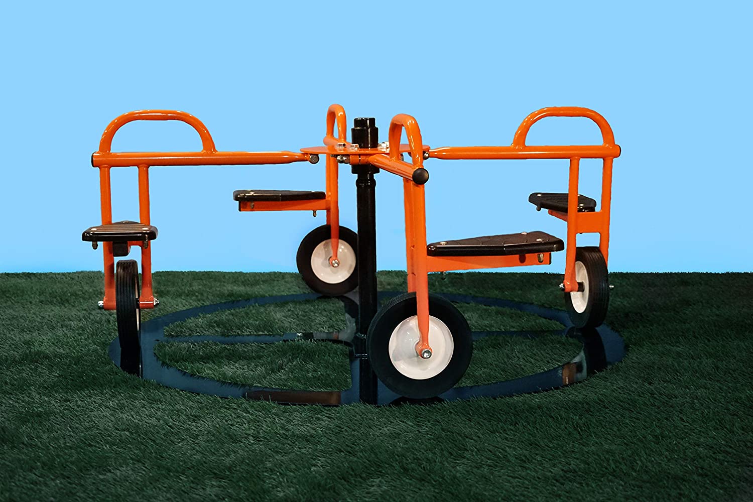 Orange metal mini merry-go-round with four black seats and white wheels on green turf
