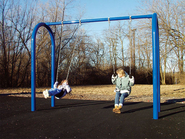 Blue heavy-duty arch swing set with two black cut-proof seats and children swinging outdoors on a clear day