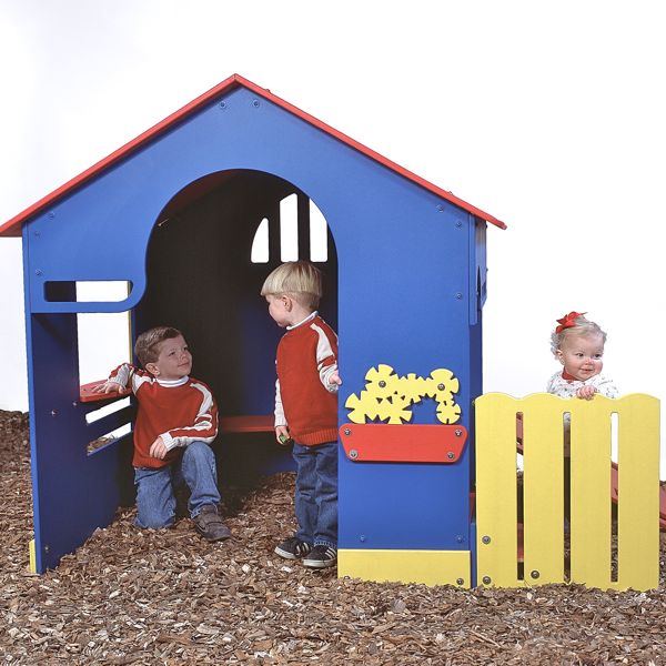 Colorful outdoor playhouse with blue, red, and yellow panels, featuring interactive gear shapes and children playing nearby