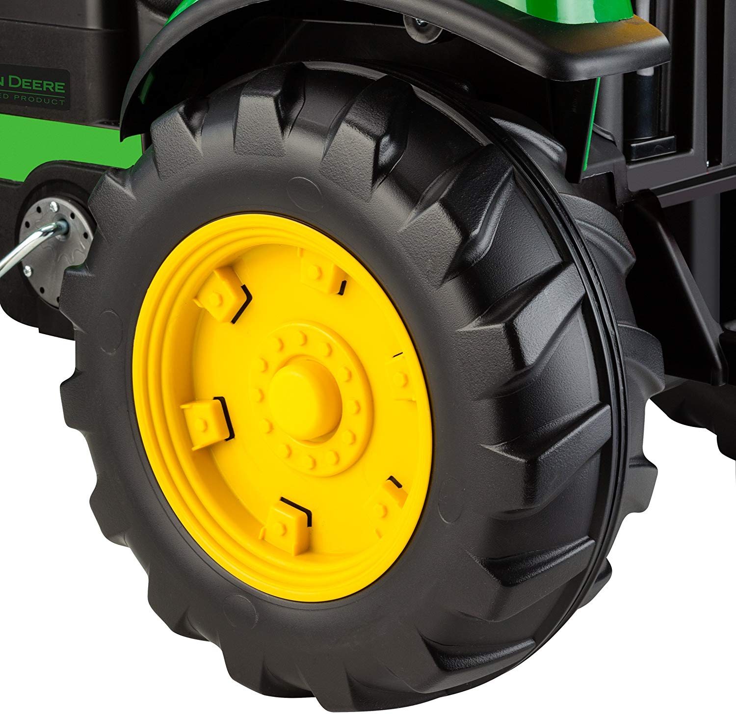Black and yellow rugged tire with heavy-duty tread on green children's pedal tractor front loader