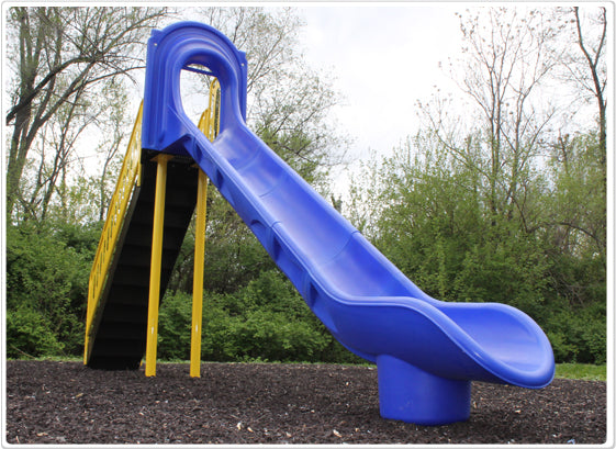 Blue high-sided independent playground slide with yellow stairs on outdoor mulch surface surrounded by trees