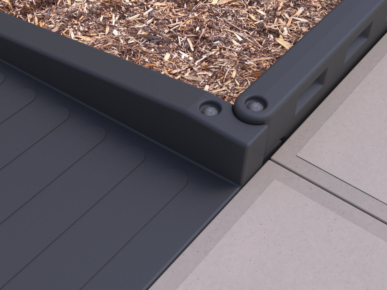 Overhead view of dark gray textured wheelchair accessible playground half ramp with mulch border