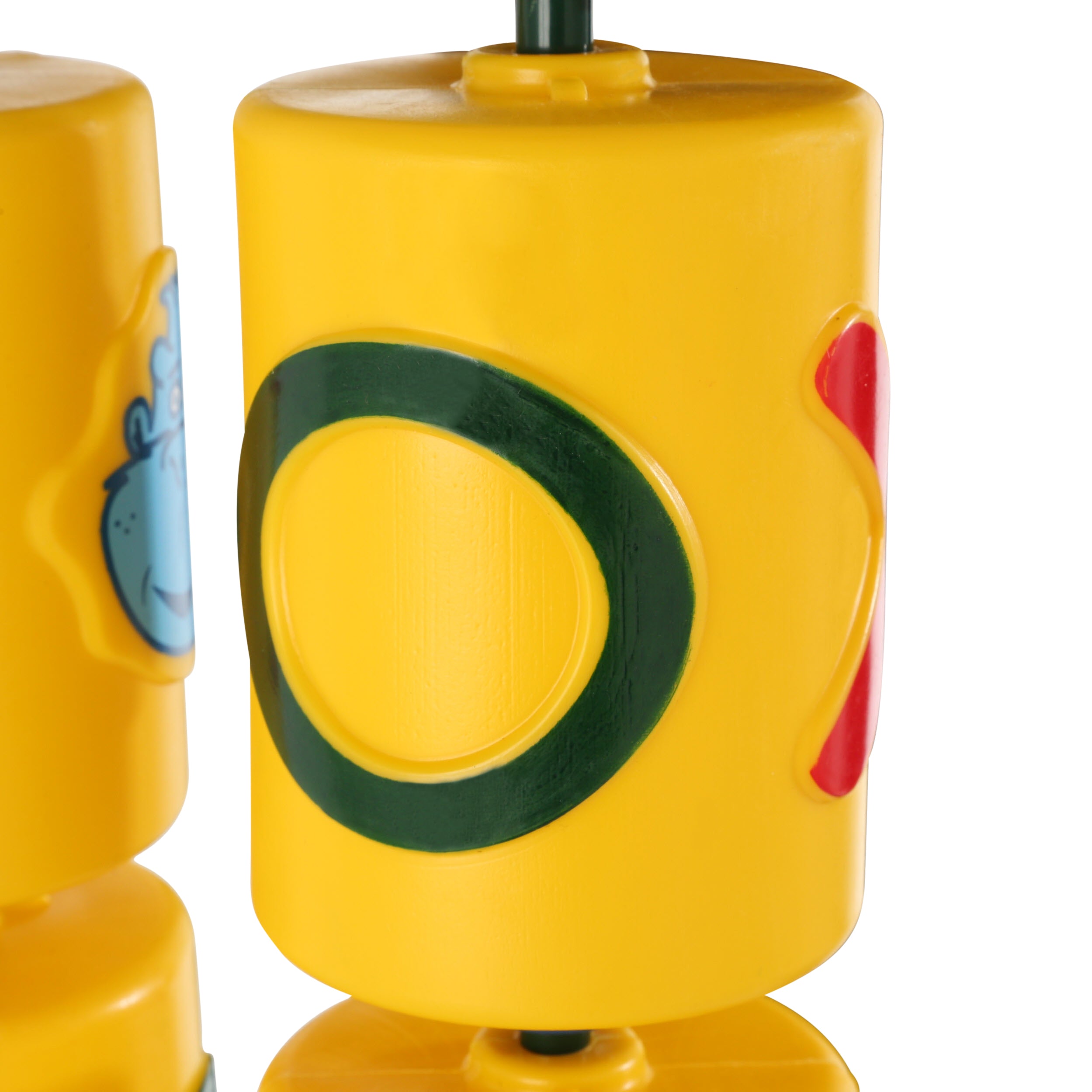 Yellow plastic spinner cylinders with green O, red X, and blue gorilla face for outdoor wooden swing set game panel