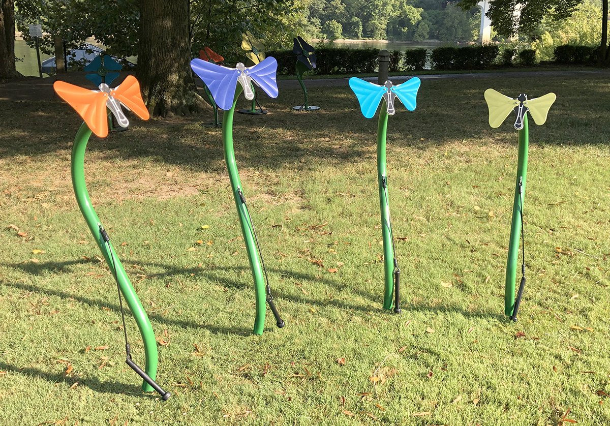 Butterflies Outdoor Musical Park Instrument with colorful butterfly-shaped anodized aluminum bells on green stems in grassy park setting
