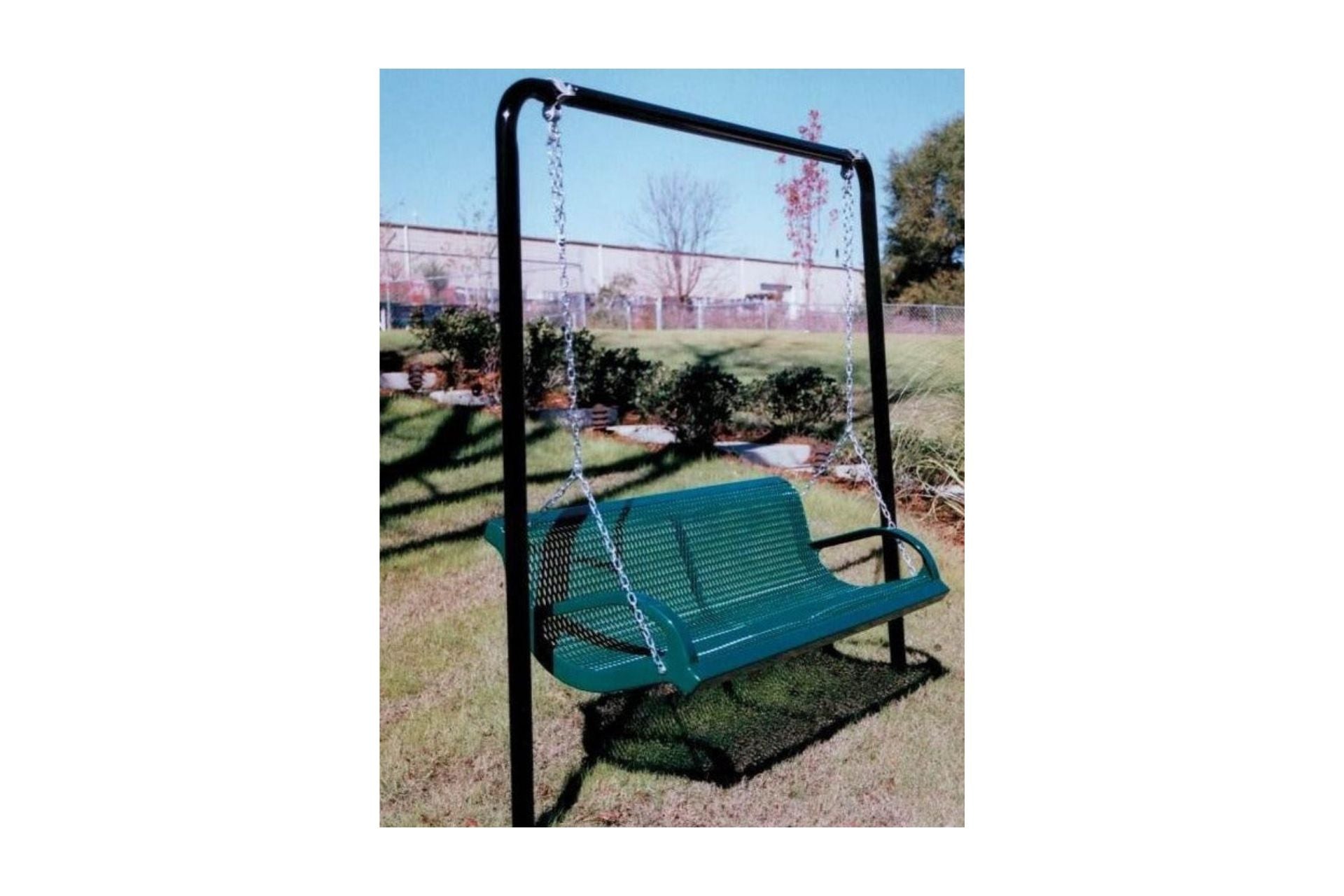 Green steel lawn swing with contoured back and armrests suspended by chains on black powder-coated steel frame in grassy outdoor setting