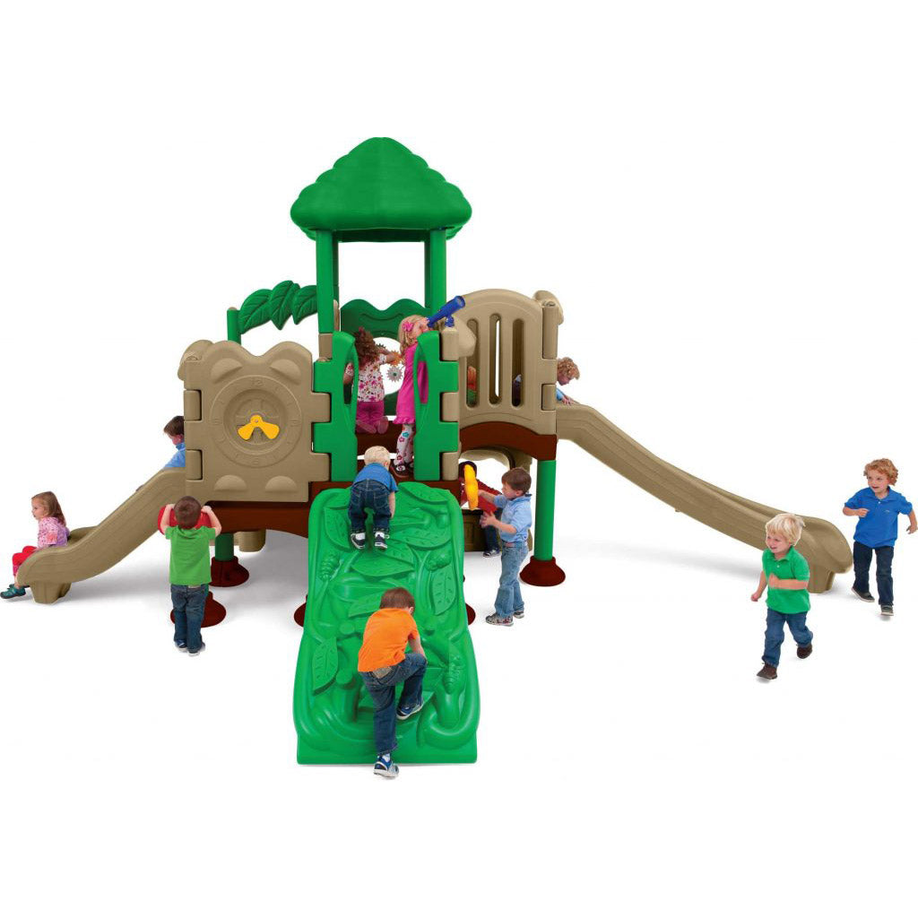 Children playing on a colorful outdoor playground with slides, climbing wall, roof canopy, and interactive panels