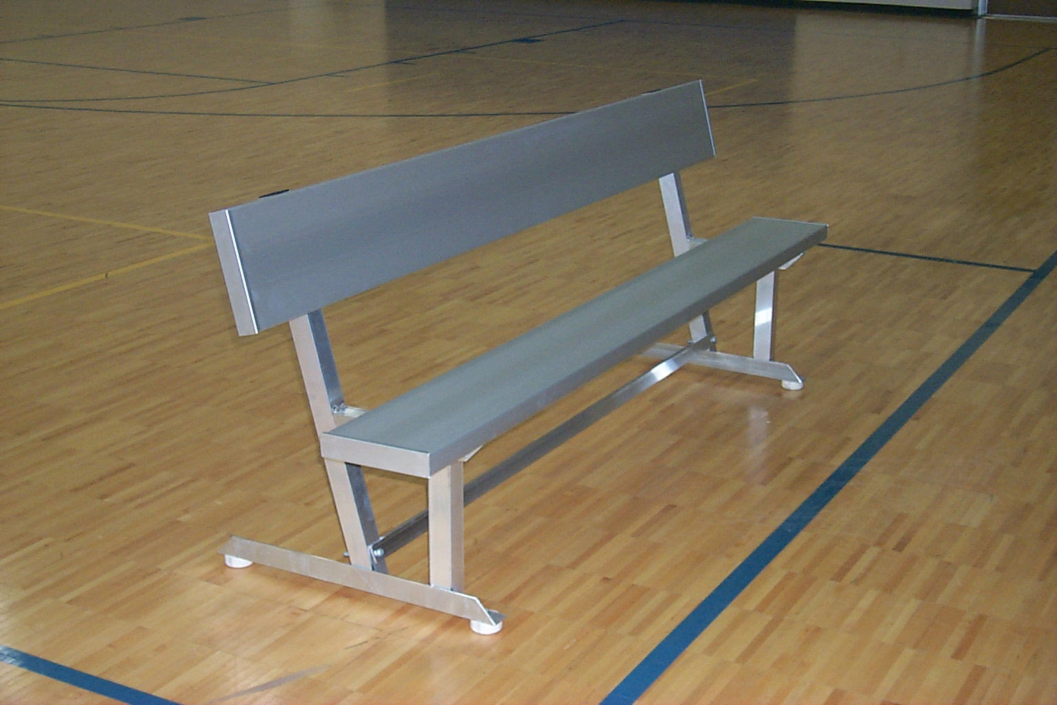 Aluminum portable bench with anodized seat planks and backrest, sturdy square tube frame on indoor gym floor
