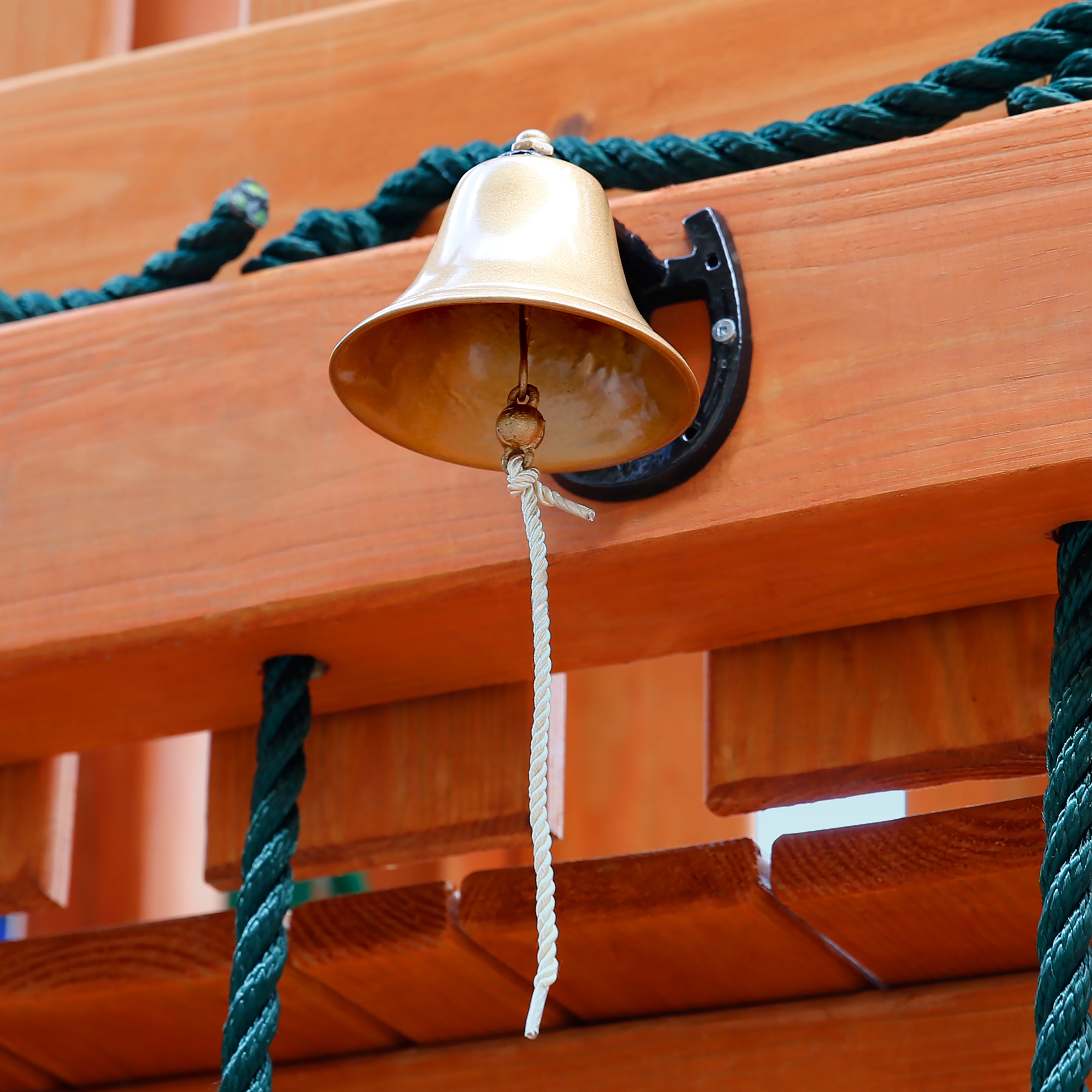 Dinner Bell Swing Set Accessory with galvanized metal bell and weatherproof string mounted on wooden playground structure