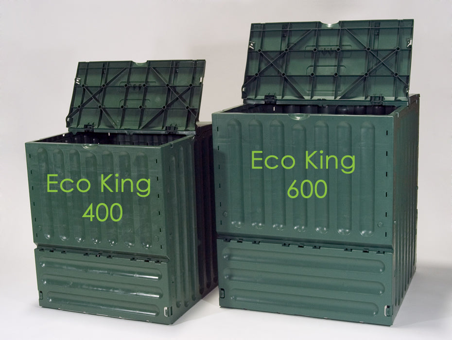 Two green vertical-ridged compost bins with open lids, labeled with capacity figures, side by side