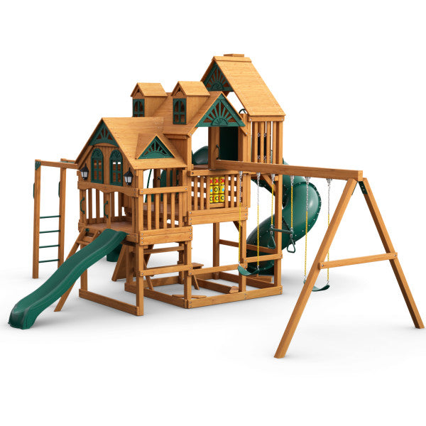 Cedar wooden playset with three decks, green slides, monkey bars, climbing wall, swings, and built-in picnic table