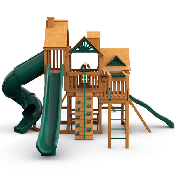 Cedar wooden playset with three decks, green tube and wave slides, rock climbing wall, monkey bars, and ladder