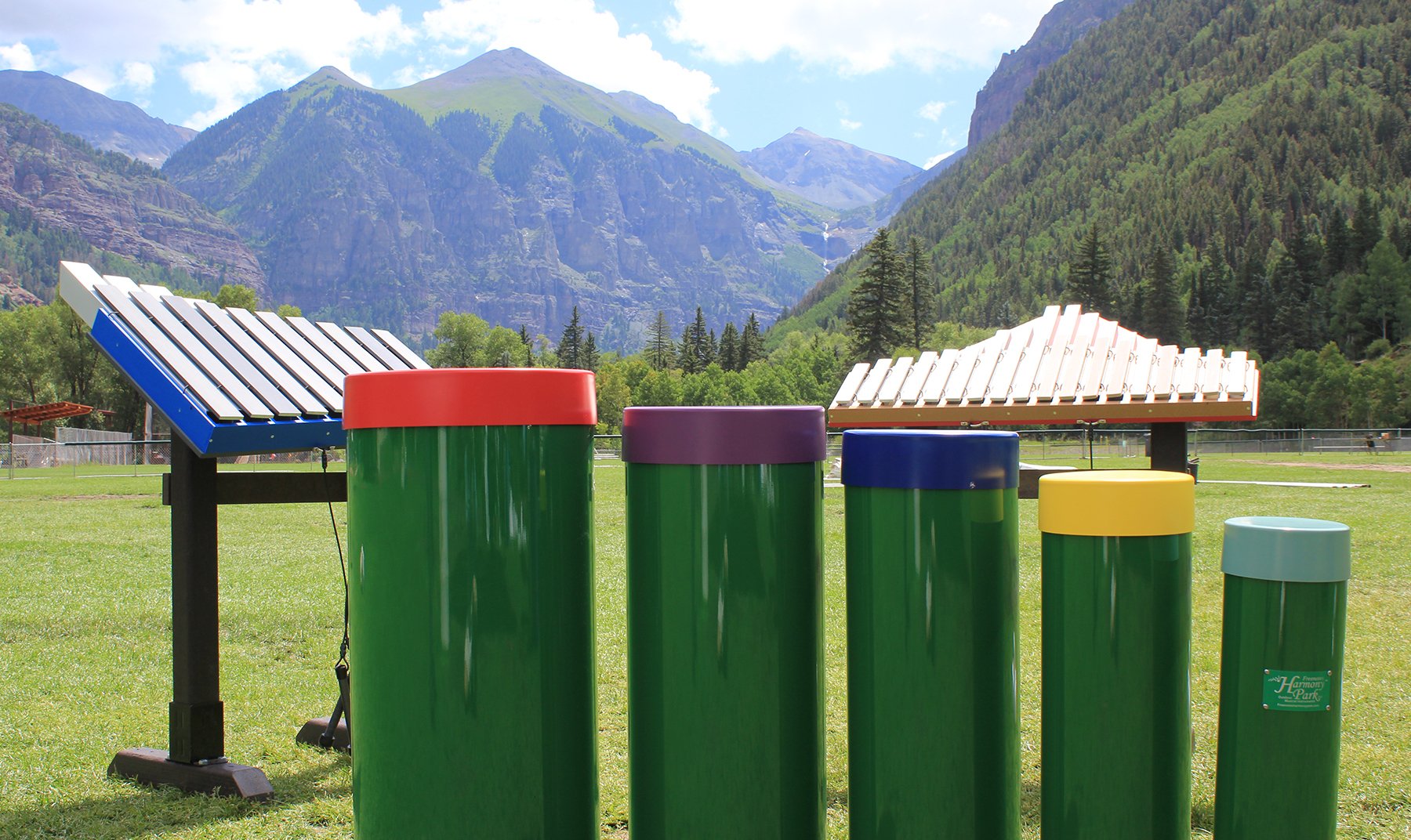 Starter Collection Outdoor Musical Park Instrument with colorful chimes and xylophones set in a scenic mountain park