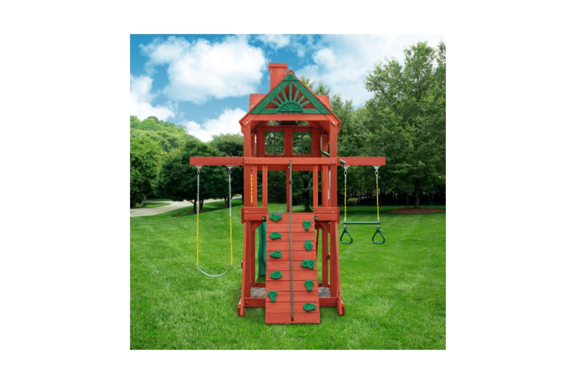 Compact wooden playset with rock climbing wall, rope, belt and trapeze swings, decorative roof, and green lawn setting