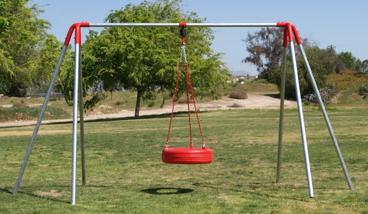 Heavy-duty metal frame swing set with a single red tire swing suspended by chains on grass