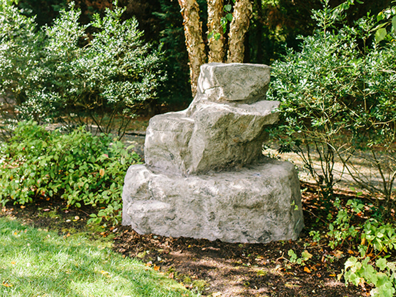 Horseshoe Bend Climbing Boulder with multi-tiered terraced and near-vertical climbing faces surrounded by greenery