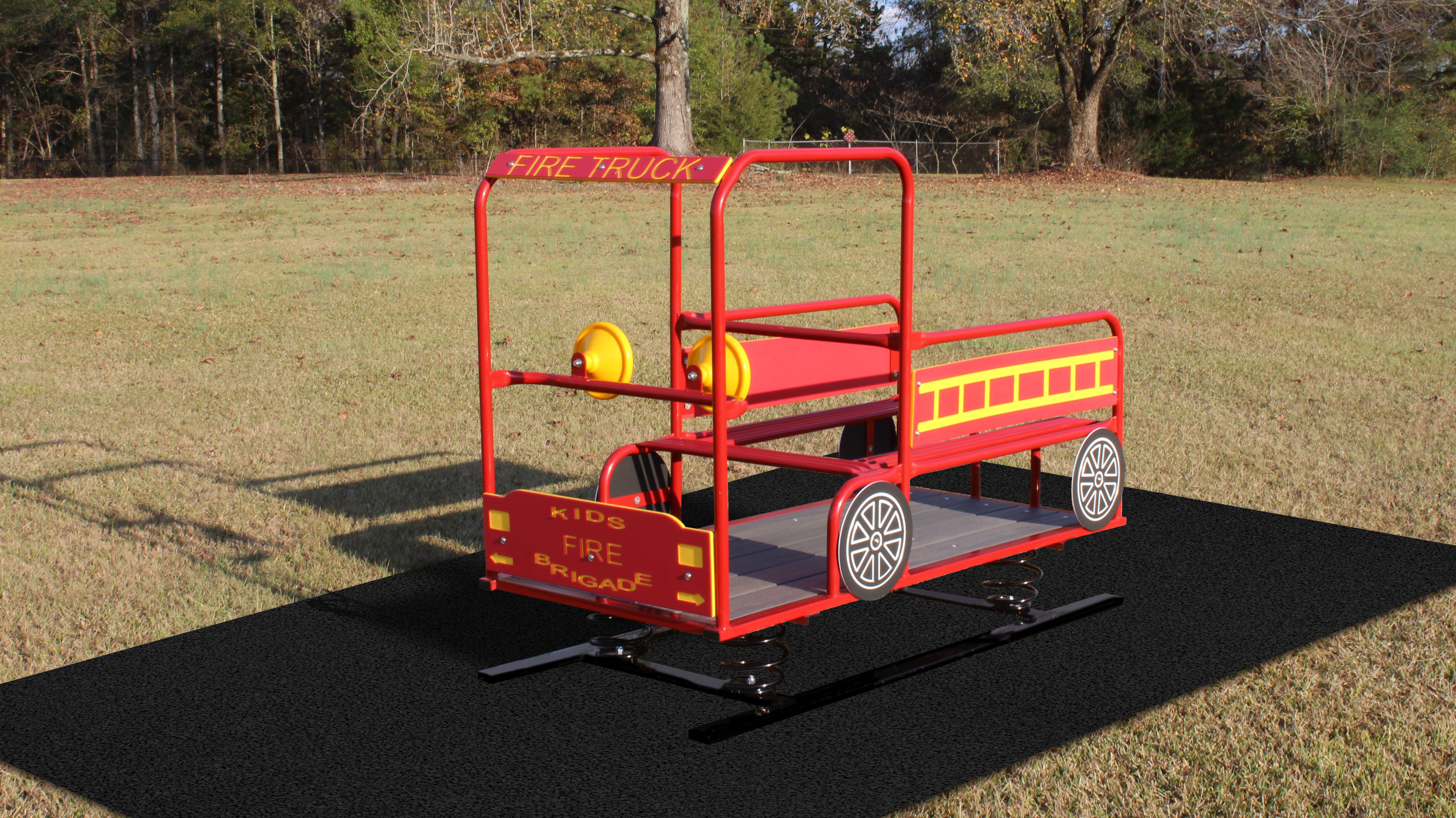 Red and yellow multi-passenger fire truck spring rider playground equipment with handrails and decorative wheels on black safety mat