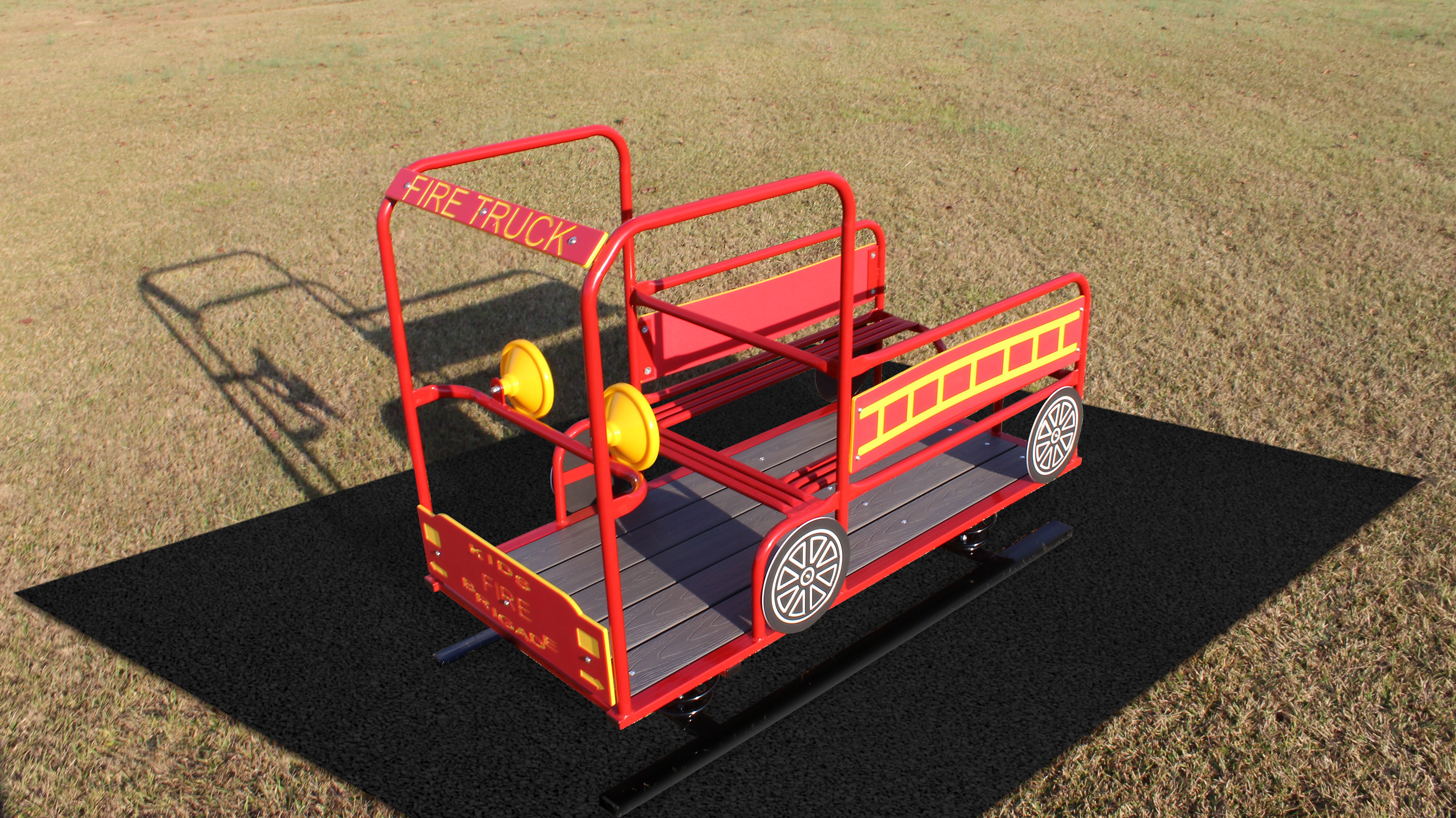 Fire Truck Multi Passenger Spring Rider with red and yellow metal frame, bench seats, steering wheels, and decorative ladder on grass