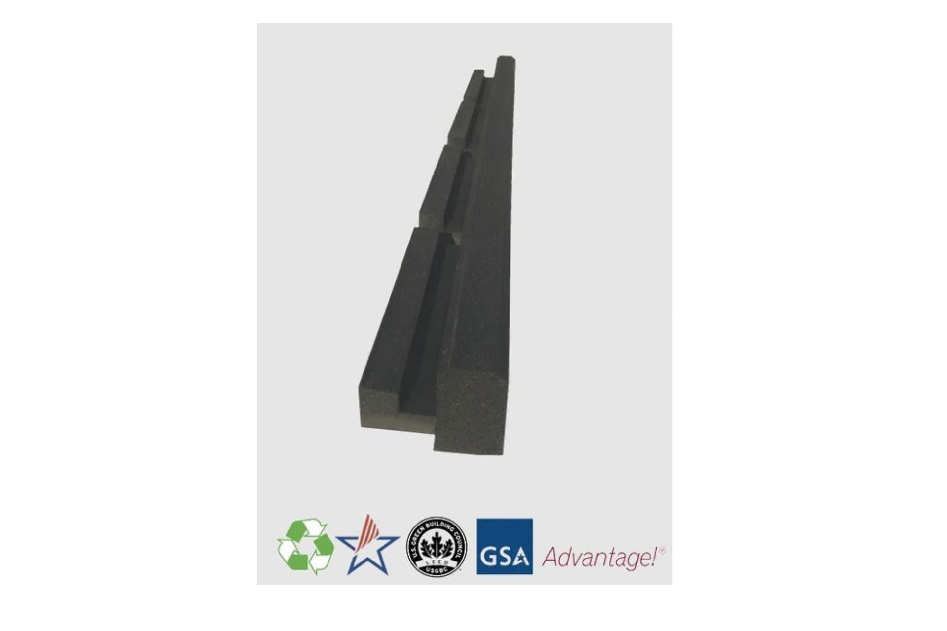 Black molded recycled rubber curb with built-in key-way and drainage outlets for playground and landscape edging.