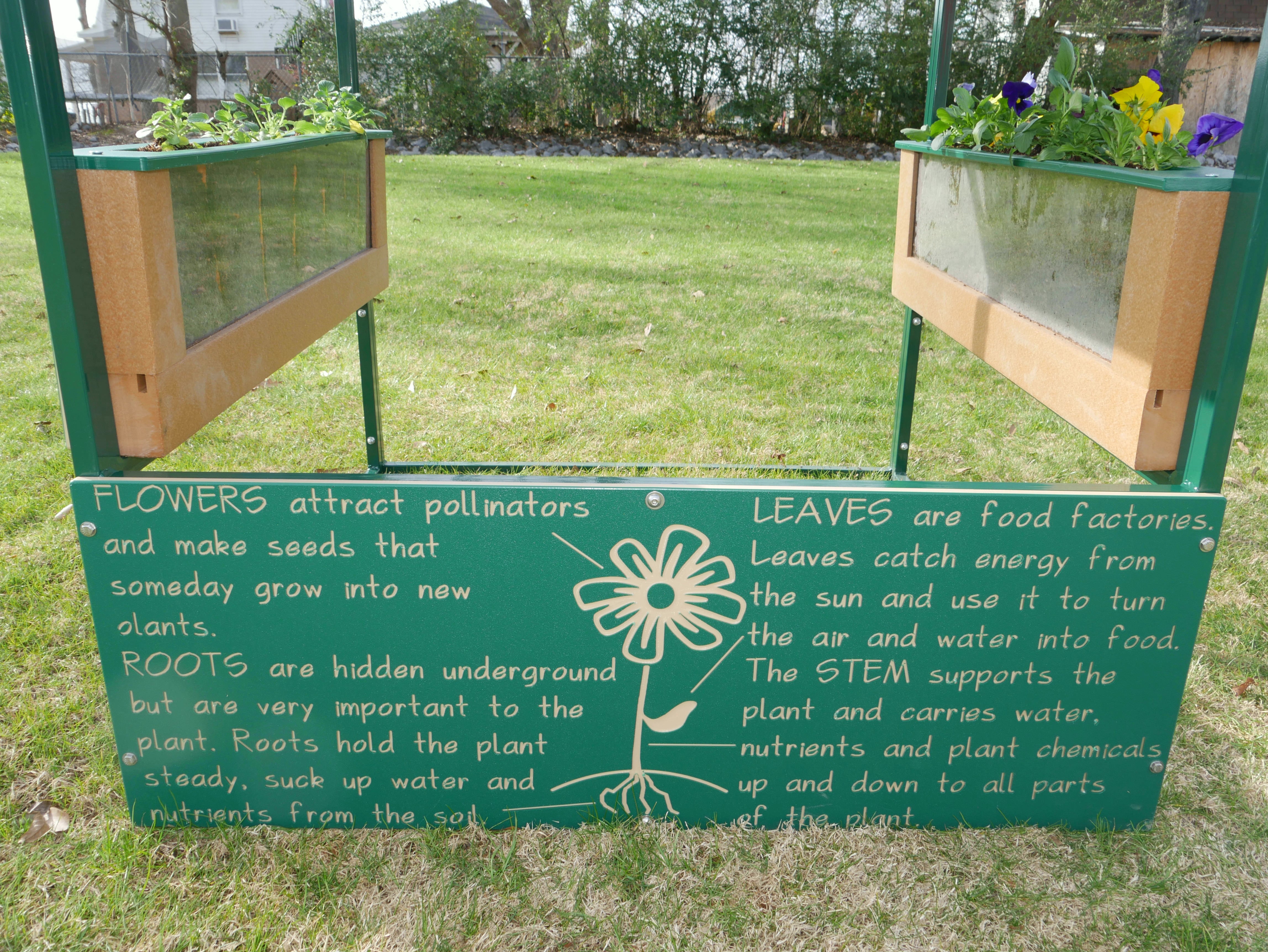 Outdoor playhouse with clear root view planters and colorful flowers, promoting hands-on gardening and plant growth learning.