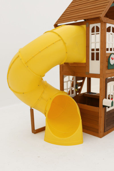 Wooden two-story playset with yellow twist tube slide, white-trimmed windows, mailbox with flag, and clubhouse