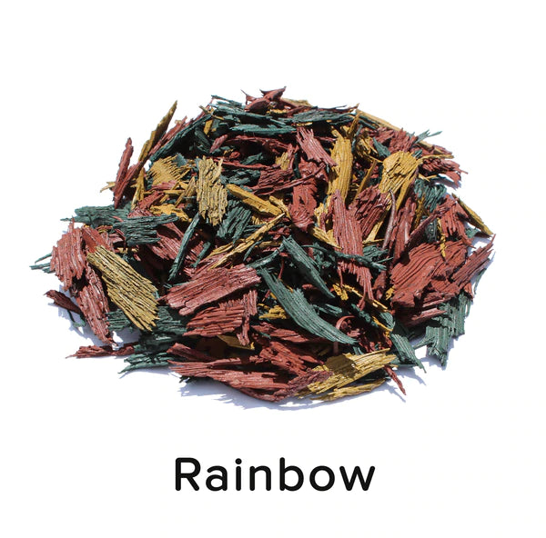 Mixed red, green, and yellow shredded recycled rubber mulch pieces for playground and landscaping ground cover