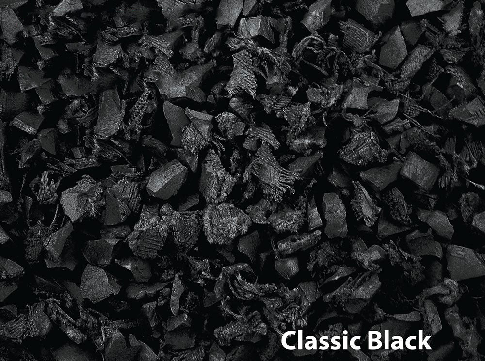 Close-up of irregularly shaped black recycled rubber playground mulch with textured, shock-absorbing surface